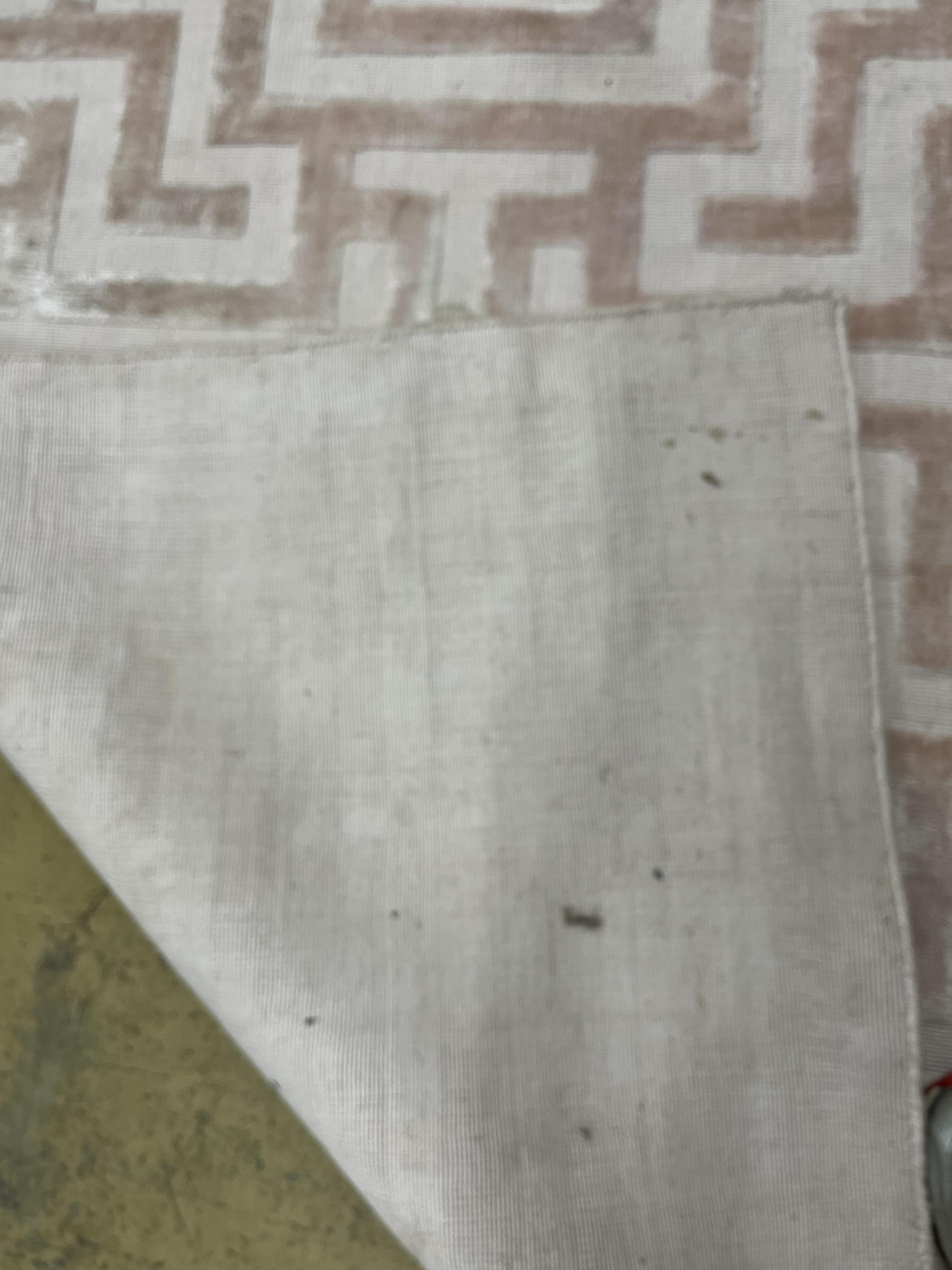 A Contemporary geometric pink ground carpet, 300 x 200cm. Condition - fair